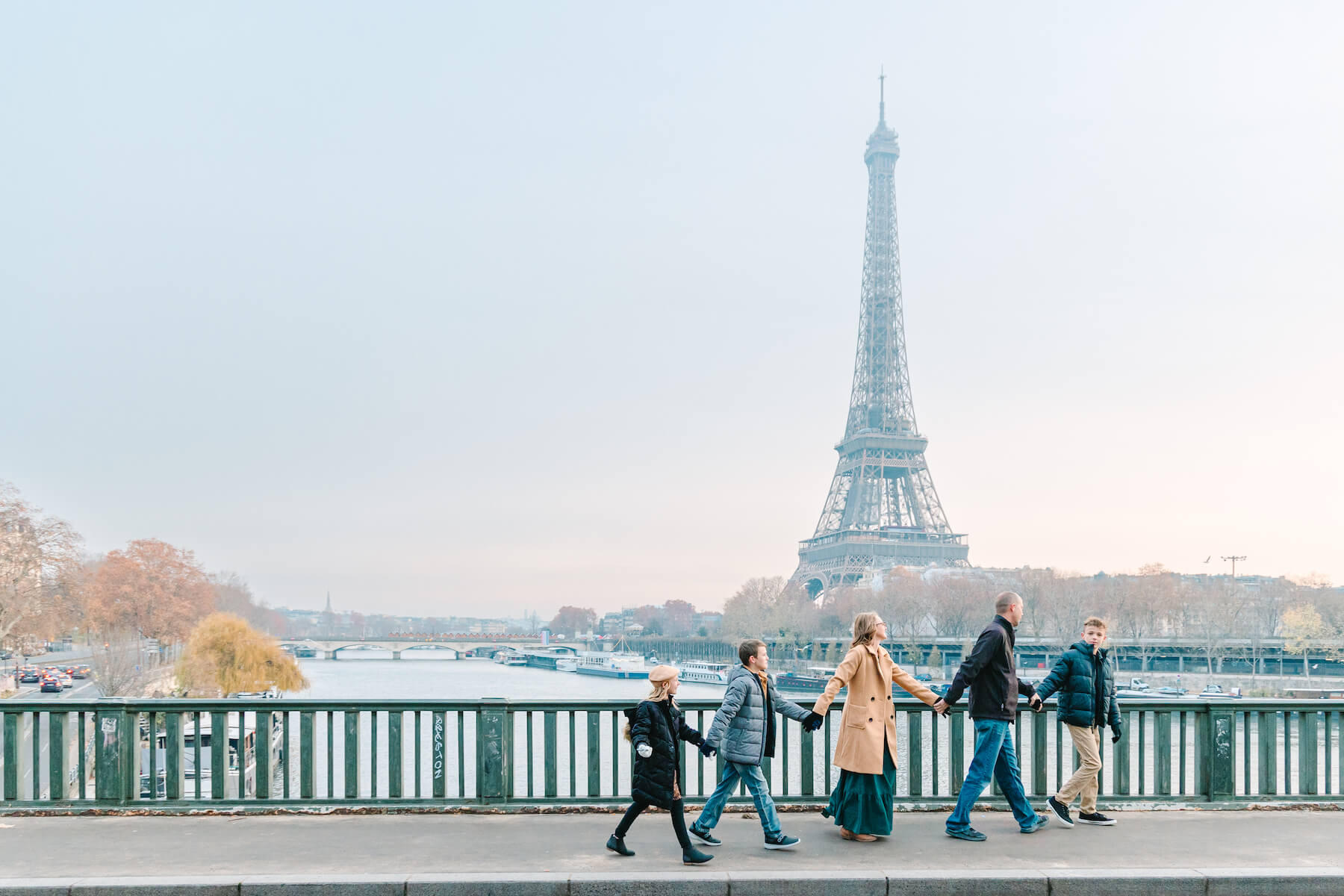Family walking in Paris by Eiffel Tower