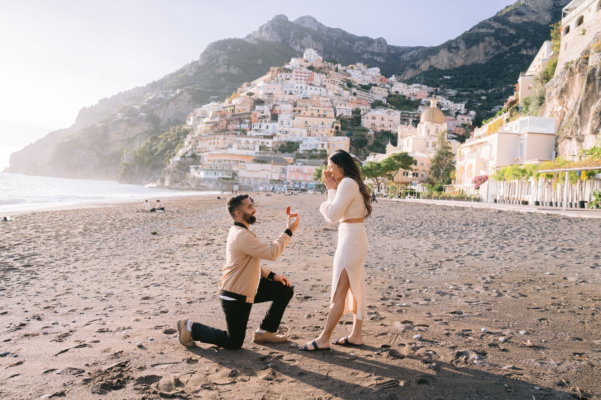 A smiling photographer meets his couple clients to start their Flytographer shoot in Santorini