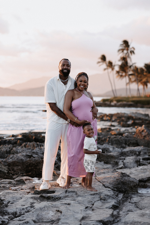 A couple and their young son pose together in Honolulu on their Flytographer photoshoot.