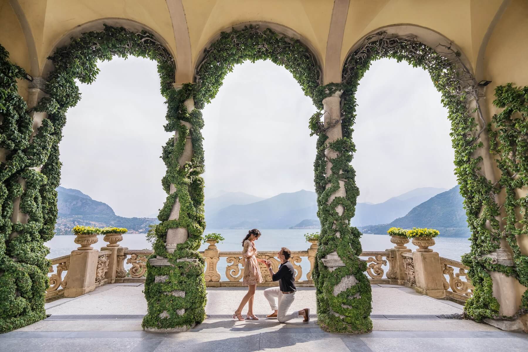 A couple getting engaged in Lake Como on a surprise proposal photoshoot with Flytographer