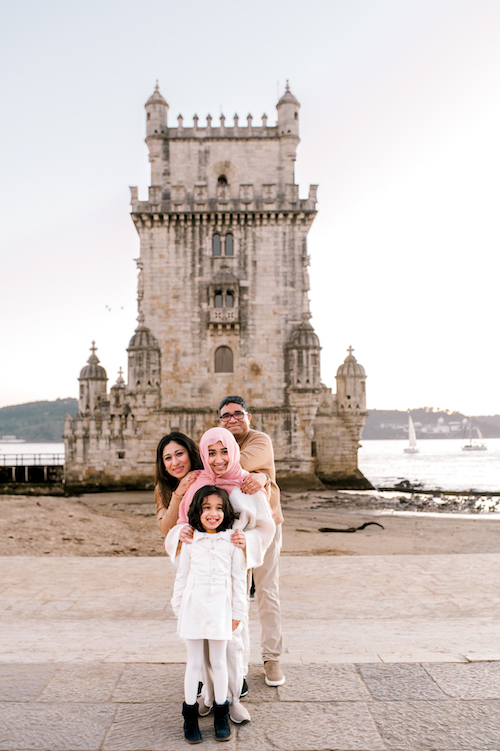A smiling family poses in Lisbon on their Flytographer photoshoot.