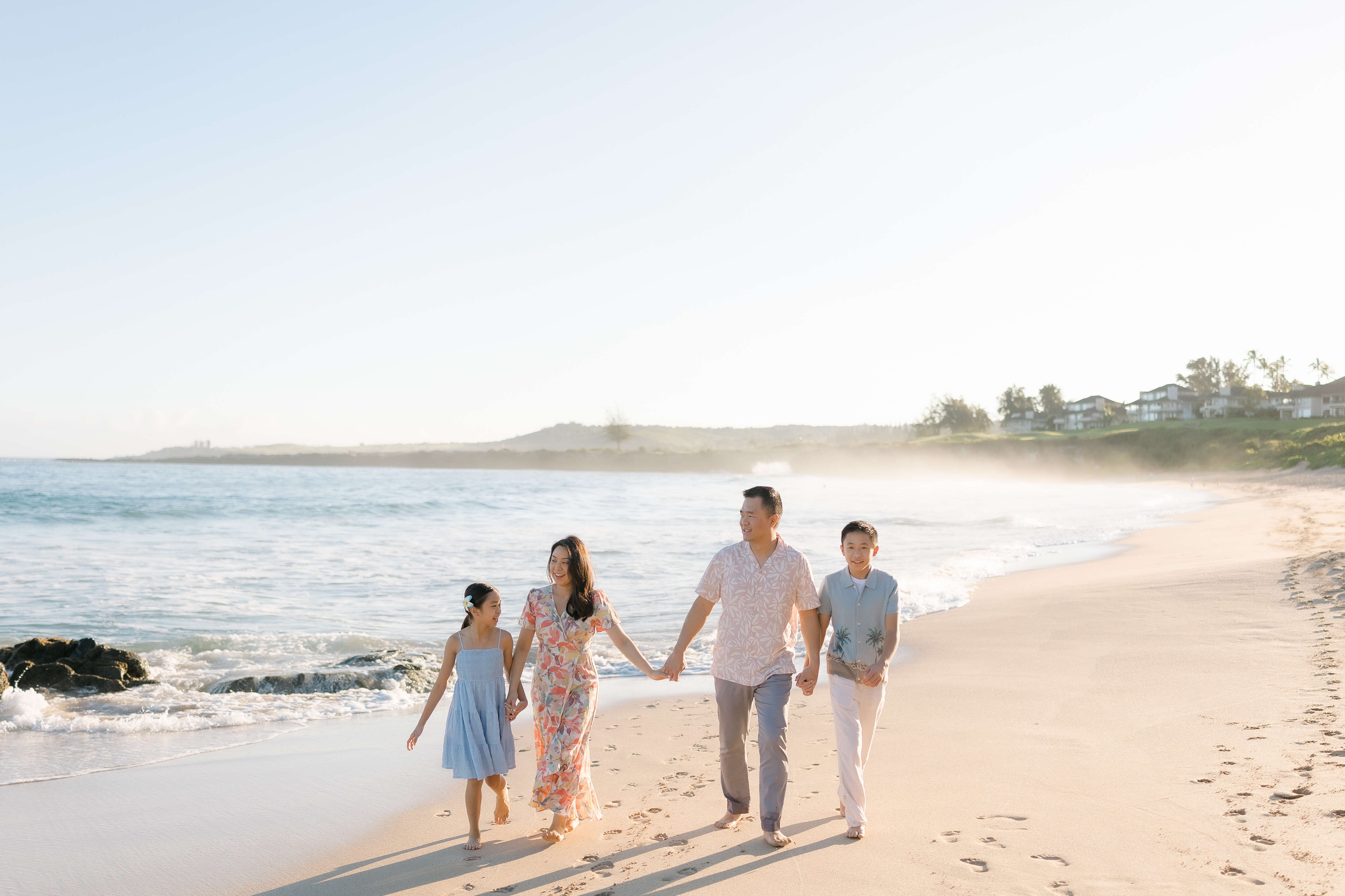 A family walking on the beach at Kapalua Ironwoods on a family photoshoot with Flytographer in Maui