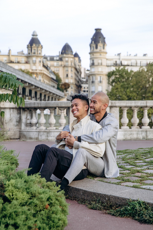 A happy couple poses near Bir Hakeim Bridge in Paris on their Flytographer photoshoot.