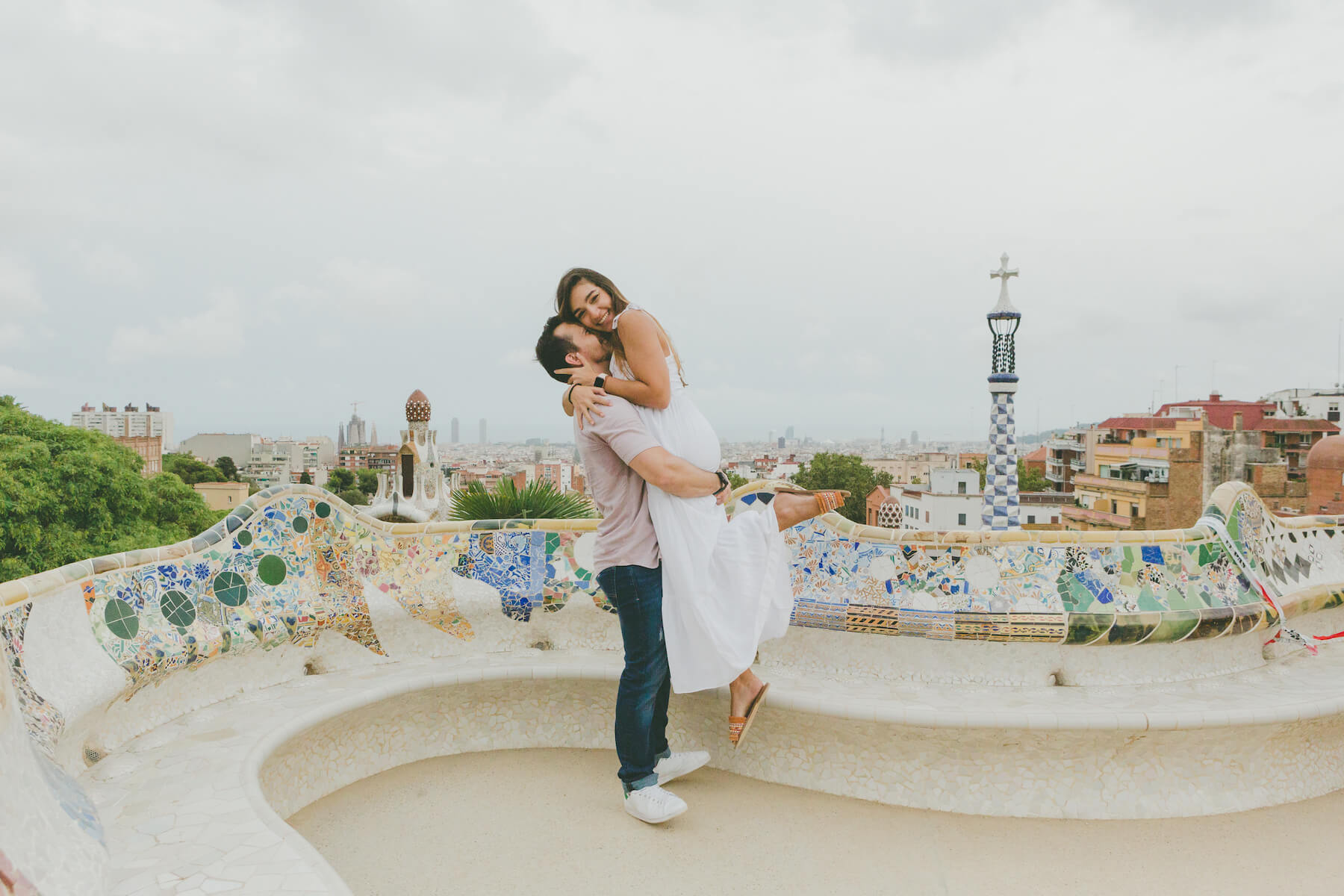 A couple hugging at Parc Guell in Barcelona on a couple photoshoot with Flytographer