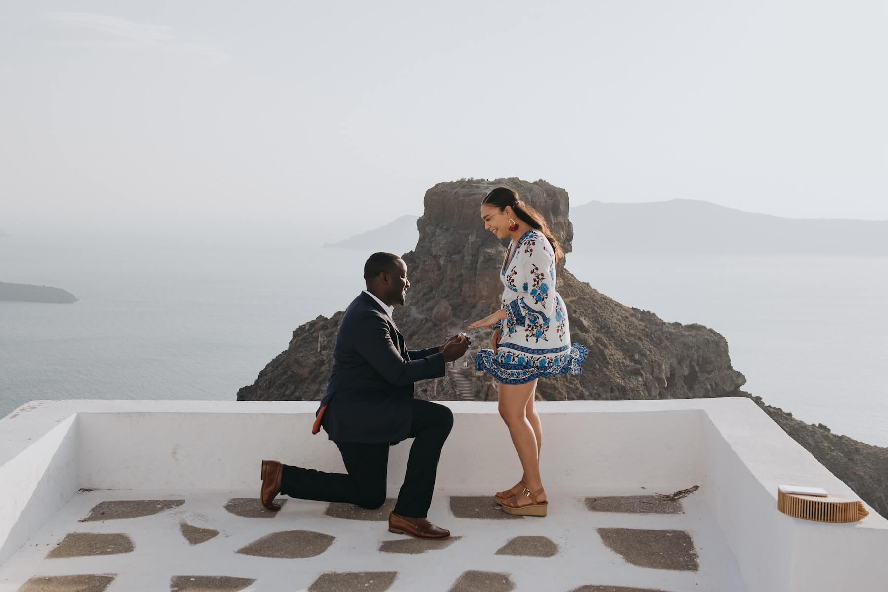 Man kneeling during Santorini surprise proposal photo session