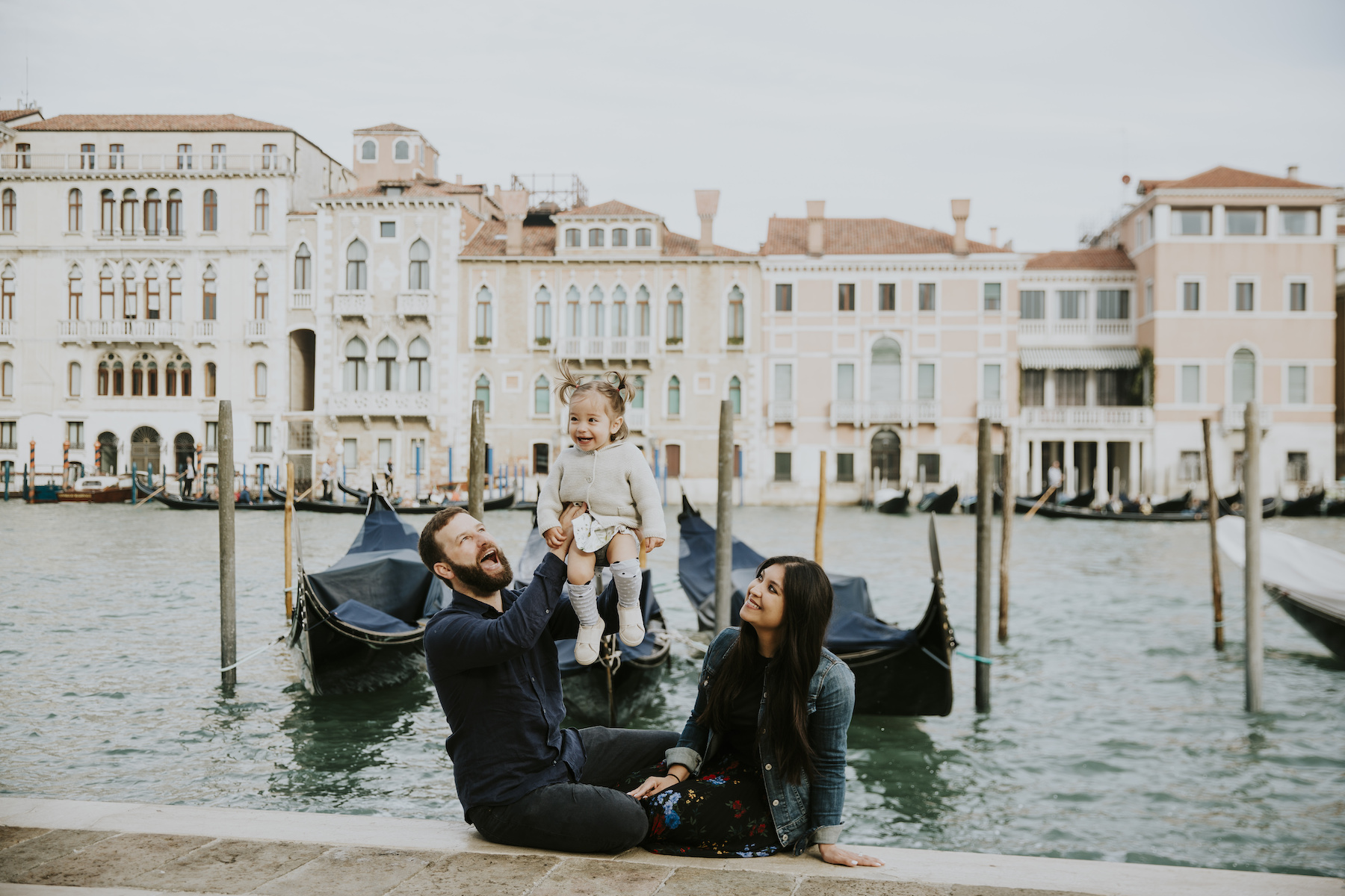 A family playing in Venice on a family photoshoot with Flytographer